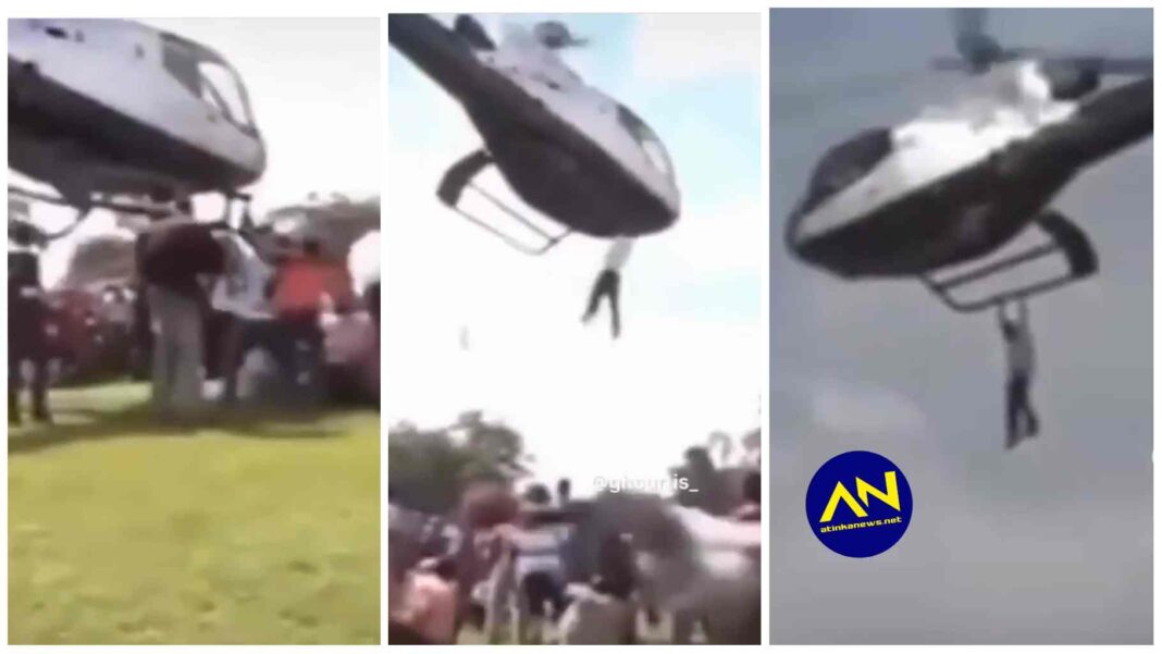 man spotted holding on to helicopter as it moves in the air